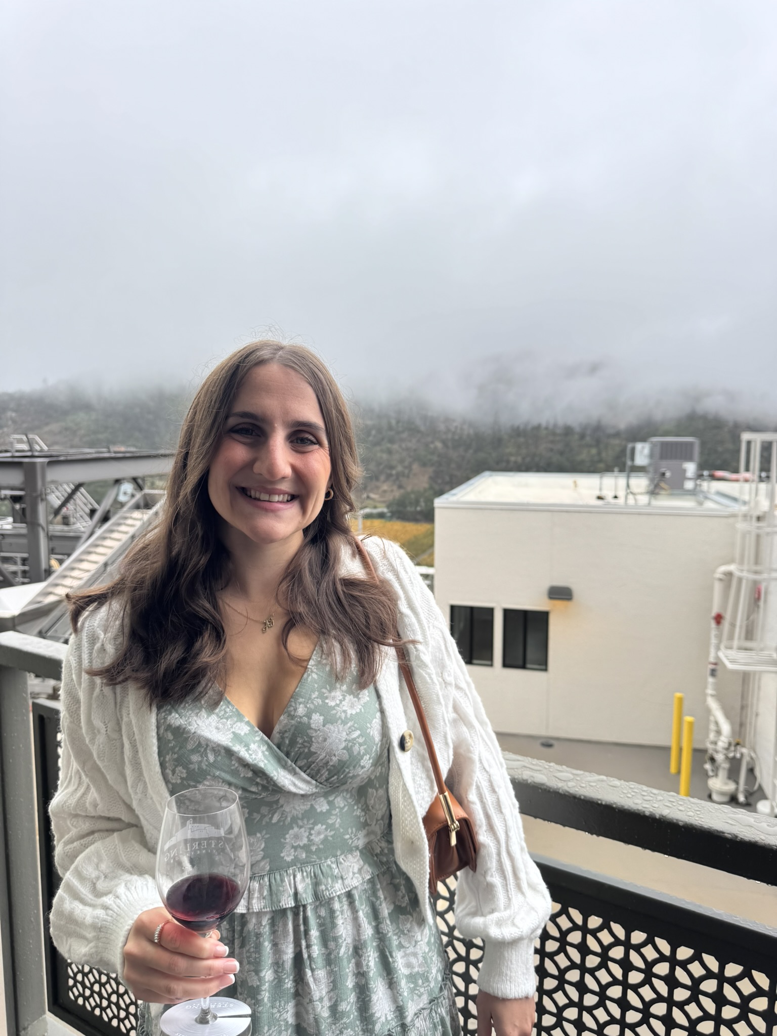 Rachel smiling outdoors in a mint floral dress